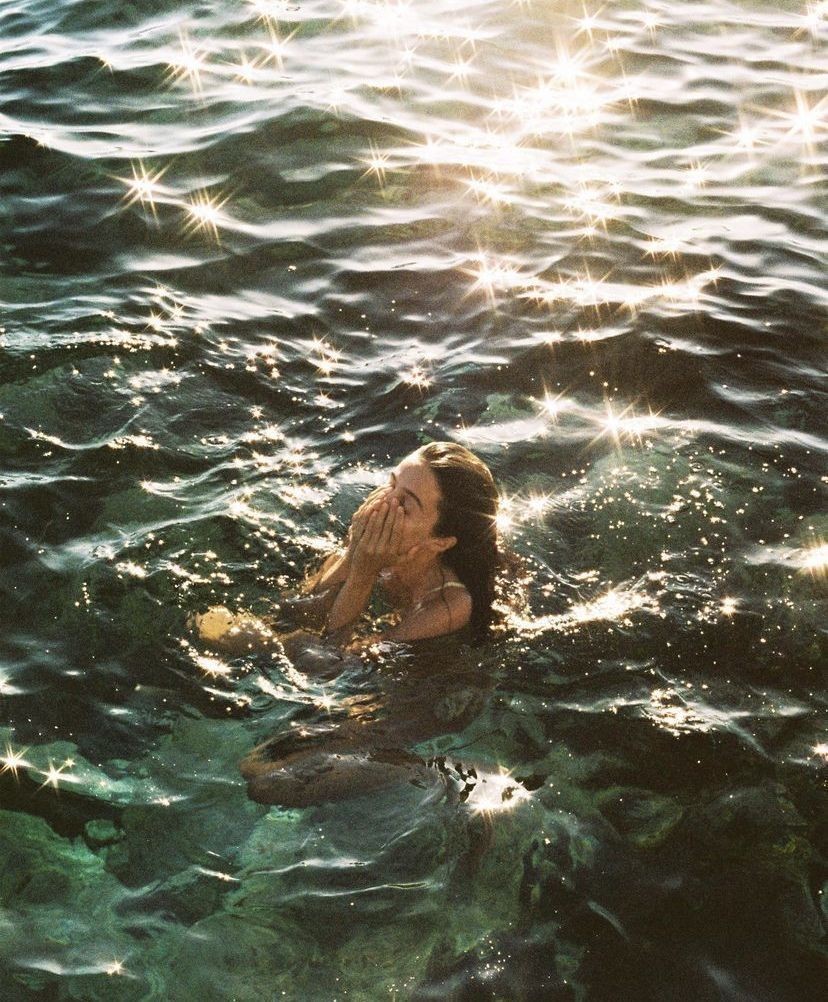 A swimmer held in sparkling water